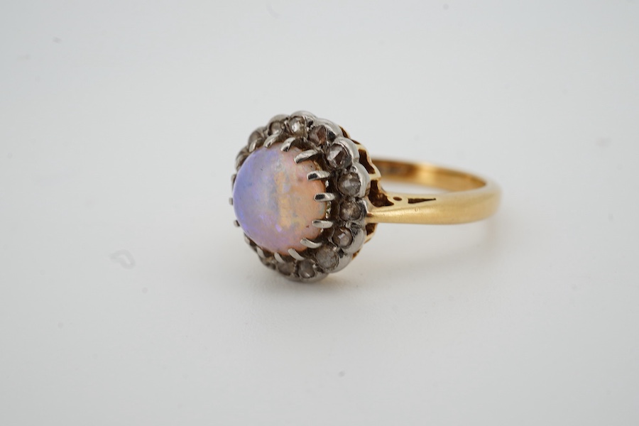An early 20th century 18ct, opal and rose cut diamond set circular cluster ring, size N/O, gross weight 4.3 grams.